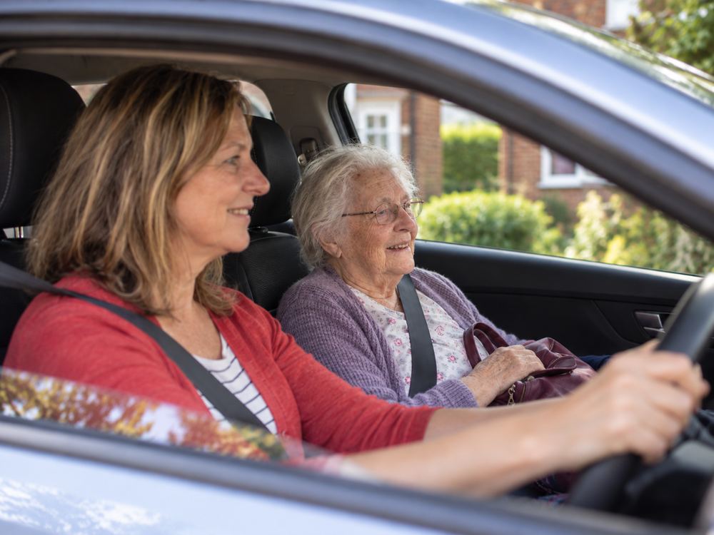 Care companion driving a client home