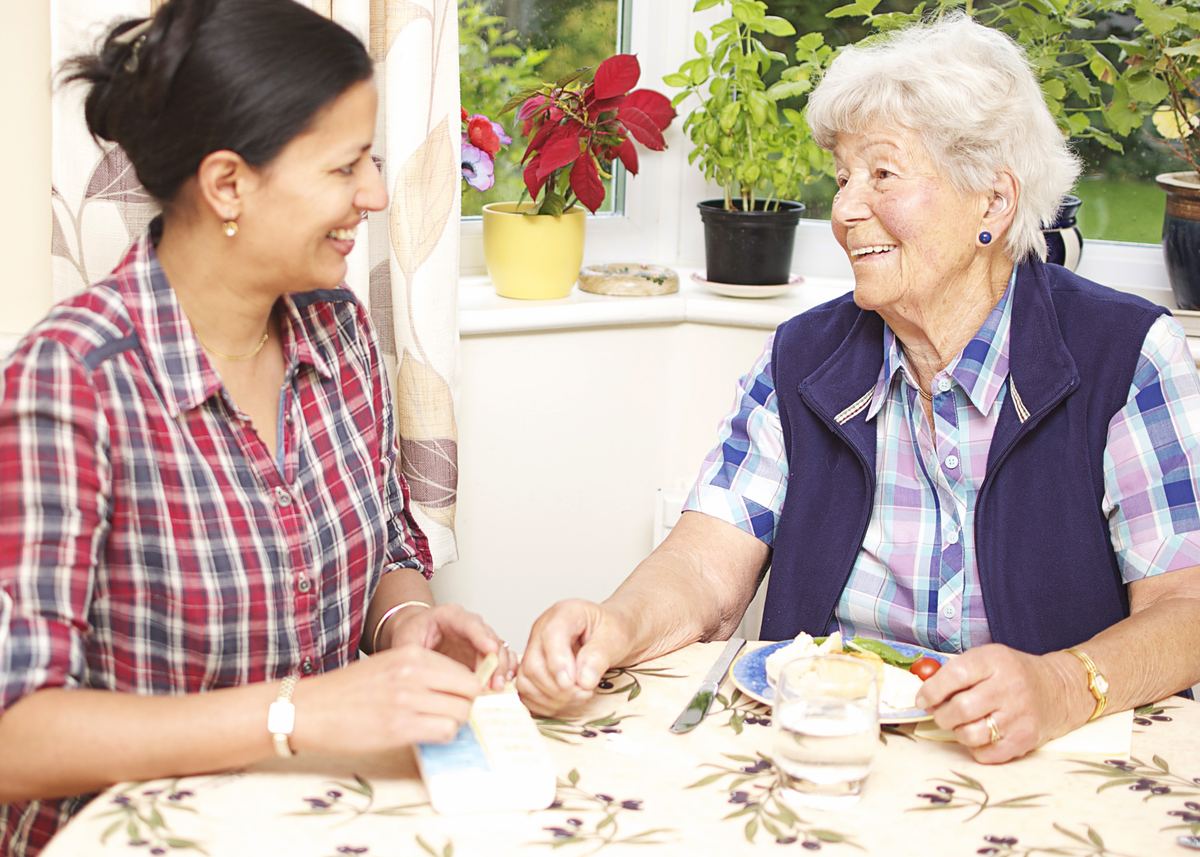 Care companion sharing lunch with a client at home