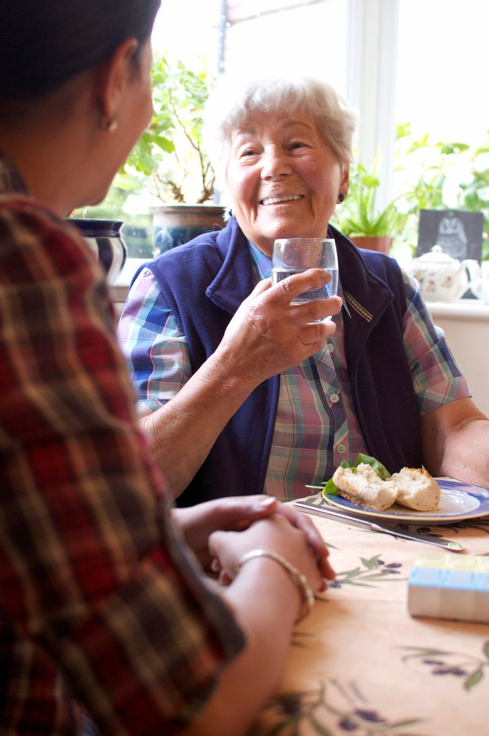 Client smiling over lunch with her care companion
