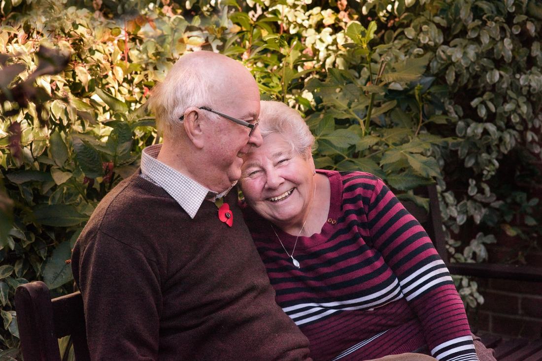 Couple sharing a laugh together in their garden