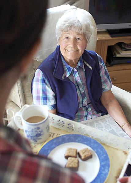 Older lady relaxing in her armchair at home